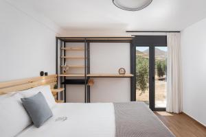 Un dormitorio con una cama blanca y una ventana. en Kourtaliotis Villa Crete, en Koxaré 75 fotos más