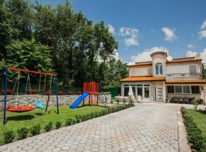 a playground in front of a house at Countryside Villa Tajo in Imotski