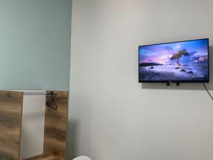 a flat screen tv on a white wall in a room at Las Palmas Guesthouse in Shkodër