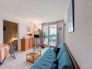 a living room with a couch and a table at Apartment Parc de Pontaillac-10 by Interhome in Pontaillac +20 photos