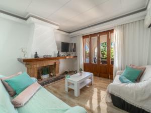 a living room with two couches and a fireplace at Villa Villa Rosa by Interhome in Port d'Alcudia
