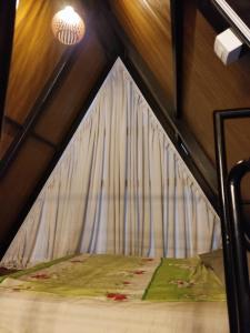 a bed in a room with a canopy at ESB Chalés in Poços de Caldas