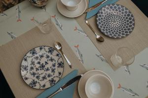 a table with plates and utensils on a table at Sweet Water Caminito del Rey in Carratraca +45 photos