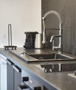 a kitchen counter with a sink and a sink at The Lafayette Charm & Practicality in the heart of Lyon in Lyon