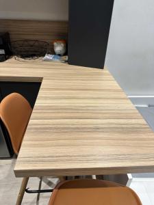 a wooden table with two chairs in a room at The Lafayette Charm & Practicality in the heart of Lyon in Lyon