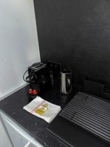 a black counter top with a toaster and a coffee pot at The Lafayette Charm & Practicality in the heart of Lyon in Lyon +9 photos