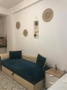 a room with a bed with a blue pillow on it at Seatime Studio in primul rând la mare in Mamaia Sat/Năvodari