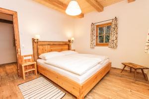 a bedroom with a large bed and a window at Chalet Die Mühle in Saalfelden am Steinernen Meer
