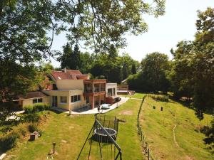 a house in the middle of a grassy field at Les gites de la maison lierue in Thiron-Gardais