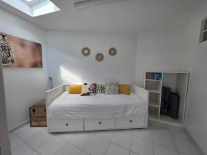a bedroom with a white bed with pillows on it at Charming townhouse for 5 people in Pontault-Combault