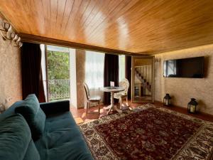 a living room with a couch and a table at Siena Hotel in Odesa +40 photos