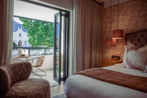 Un ou plusieurs lits dans un hébergement de l'établissement Le Petit Manoir Boutique Hotel