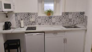 a kitchen with a sink and a counter top at La Casita de Mari in Estepona