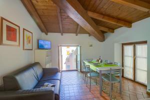a living room with a couch and a table at Casa Alpino in Riva del Garda