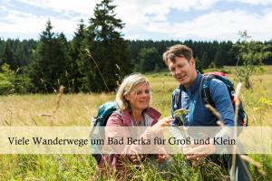 a man and a woman standing in a field at Ferienwohnung Auszeit am Kurpark Bad Berka # Balkon # ruhige Lage # gratis Parkplatz & WLAN # Weimarer Land # nahe Weimar & Erfurt in Bad Berka