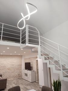 a spiral staircase in a room with a living room at Il canto del mare in Giovinazzo