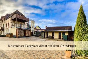 a building with a tree in front of it at Ferienwohnung Auszeit am Kurpark Bad Berka # Balkon # ruhige Lage # gratis Parkplatz & WLAN # Nähe Weimar # Weimarer Land in Bad Berka +35 photos
