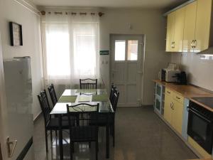 a kitchen with a table and chairs in a room at Martin Vendégház in Arnót