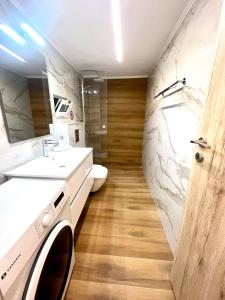 a bathroom with a sink and a washing machine in it at Your Stylish Home near Centre in Thérissos