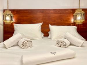 a bed with two rolled towels on it at Your Stylish Home near Centre in Thérissos