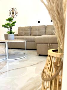a living room with a couch and a table at Your Stylish Home near Centre in Thérissos