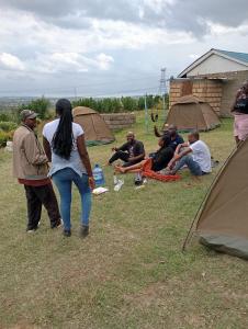a group of people in a field with tents at Longonot View Camp and Accommodation, Naivasha in Naivasha +13 photos