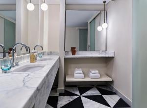 a bathroom with two sinks and a mirror at The Chedi El Gouna in Hurghada