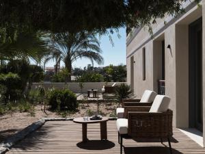 a patio with chairs and a table on a deck at The Chedi El Gouna in Hurghada