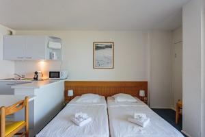 2 Betten in einem kleinen Zimmer mit Küche in der Unterkunft Studio Helder vue mer - Welkeys in Biarritz + 4 Fotos