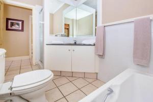 克尼斯纳Pezula Golf Villa的带马桶、水槽和浴缸的浴室