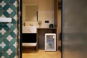 a small refrigerator in a kitchen next to a counter at Chongqing Shangshanzhu Riverside View Homestay in Chongqing +35 photos