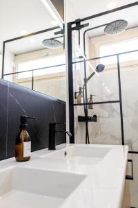 a bathroom with a sink and a mirror at Gite Au Charme des Iris in Plérin +23 photos