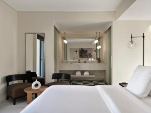 a bedroom with a bed and a living room at The Chedi El Gouna in Hurghada