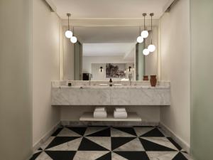 a bathroom with a large sink and a mirror at The Chedi El Gouna in Hurghada