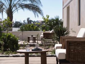 a table with a glass of wine on a patio at The Chedi El Gouna in Hurghada