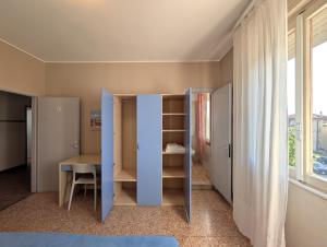a room with a desk and a table and a window at Alloggi San Marco in Caorle