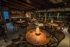 a restaurant with wooden tables and chairs and a bar at San Juan Jaguariaiva in Jaguariaíva