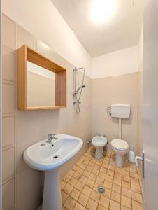 a bathroom with a sink and a toilet at Alloggi San Marco in Caorle