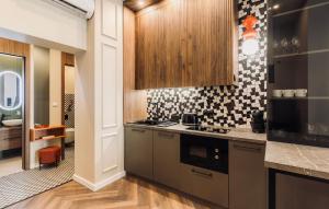 a kitchen with a stove and a microwave at 2 - Dolce Antoinette - DonViore in Győr