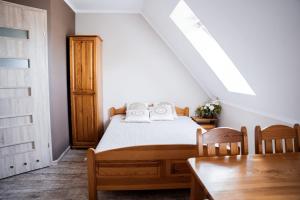 a bedroom with a bed and a dining room table at Gospodarstwo Agroturystyczne Joanna Jasińska in Dąbki +23 photos