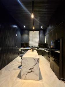 a kitchen with a table in the middle of it at Jaiye Villa in Lekki +56 photos