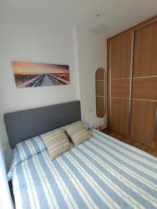 a bedroom with a bed with two pillows on it at La Casita de Vane - Casa en el centro con parking privado a unos 250 metros in Cangas de Morrazo +37 photos