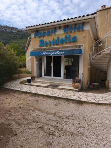 a building with a sign that reads arrow hotel restaurant at Residella hôtel in Gémenos