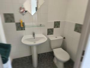 a small bathroom with a sink and a toilet at Residella hôtel in Gémenos