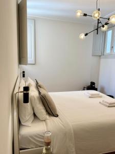 a bedroom with a bed with white sheets and pillows at Santa Justa Cozy Room in Lisbon