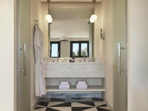 a bathroom with a large sink and a large mirror at The Chedi El Gouna in Hurghada