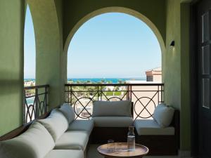 a living room with a couch on a balcony at The Chedi El Gouna in Hurghada