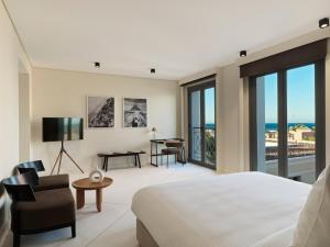 a bedroom with a bed and a view of the ocean at The Chedi El Gouna in Hurghada
