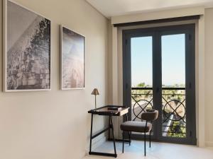 a room with a table and a chair and a window at The Chedi El Gouna in Hurghada