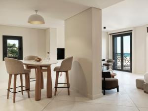 a dining room and living room with a table and chairs at The Chedi El Gouna in Hurghada